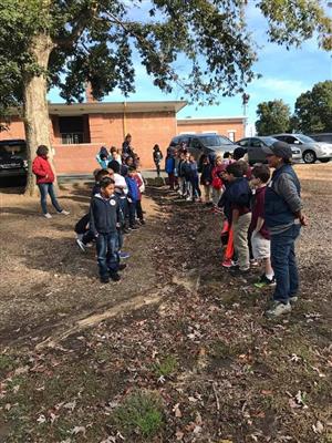 students looking at erosion on playground